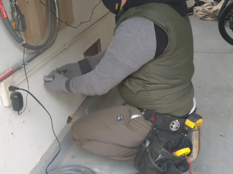 Electrician performing outlet wiring in a Upper Hanover garage